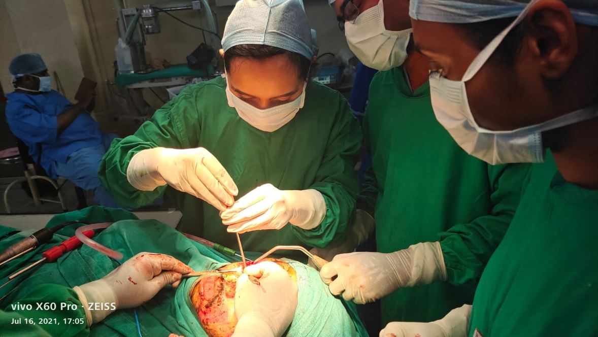 Dentist performing procedure under mentor supervision